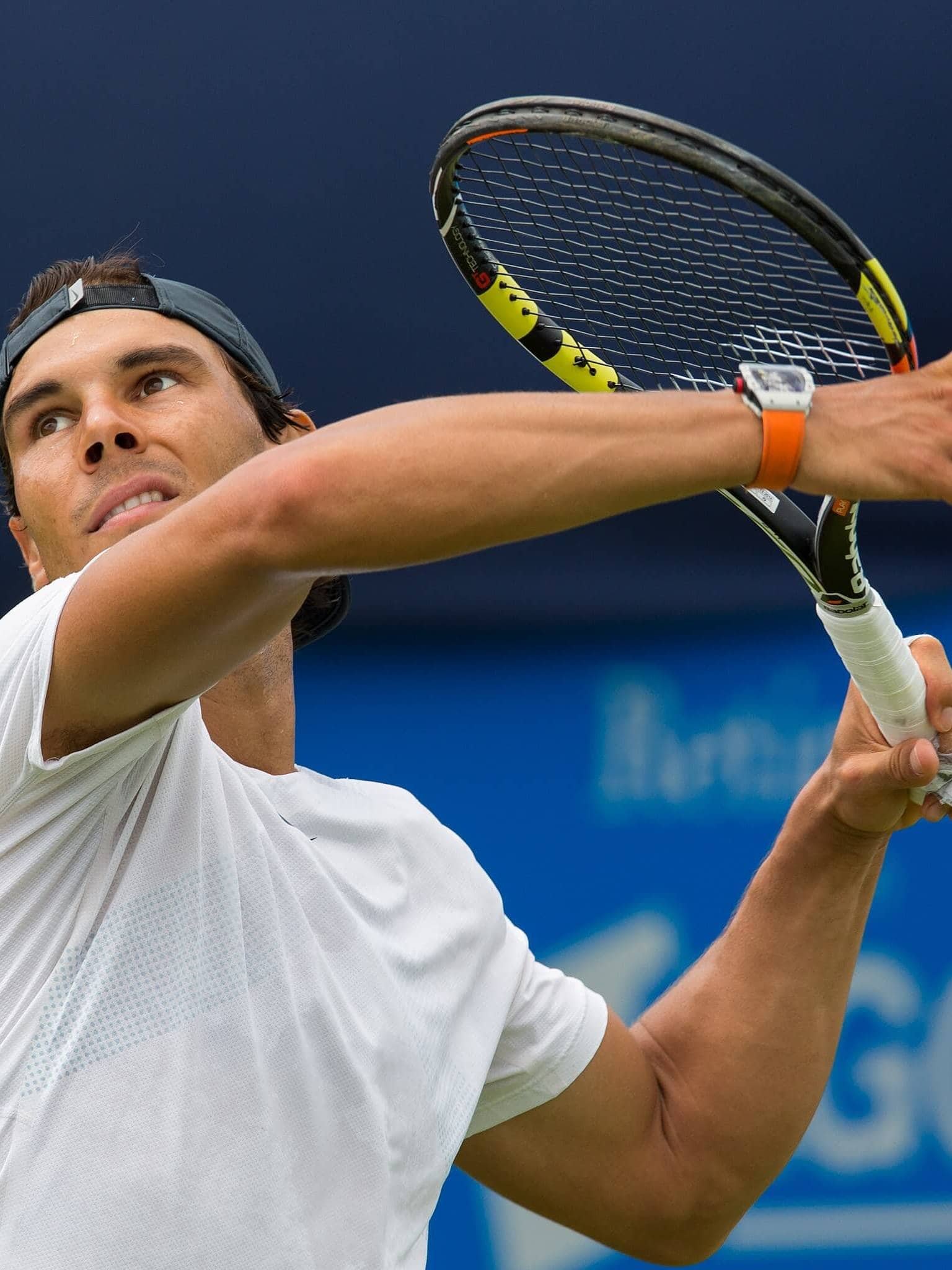 Rafael Nadal preparing to hit a tennis ball with focus and strength.