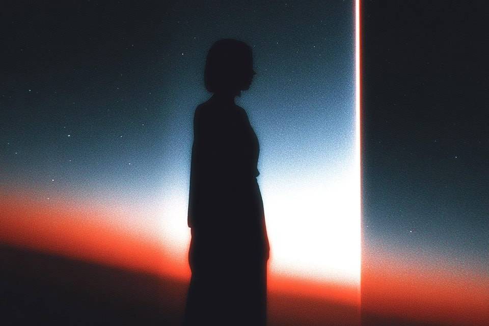 Silhouette of a person standing before a glowing doorway in a cosmic setting.