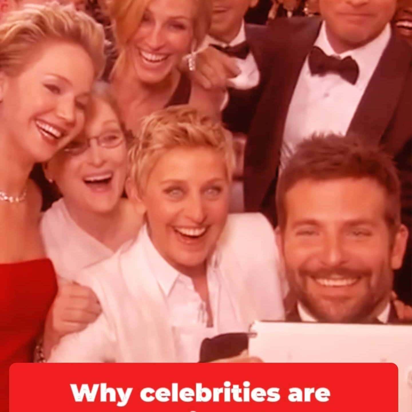 Selfie with smiling celebrities at an event, glamorous attire and joyful expressions.