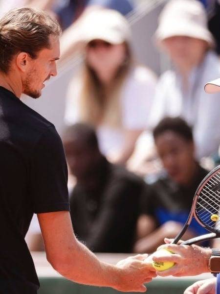 Tennis player Alexander Zverev with his father on the court during a match.