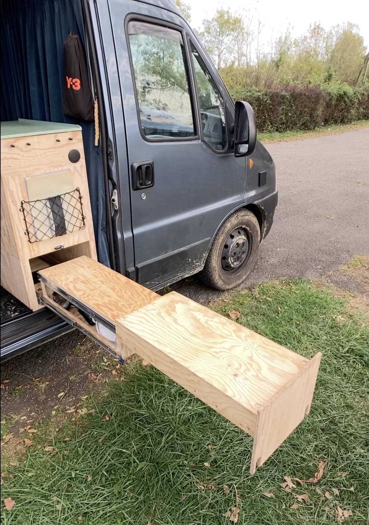 Wooden drawer being installed in a camper van for custom furniture.