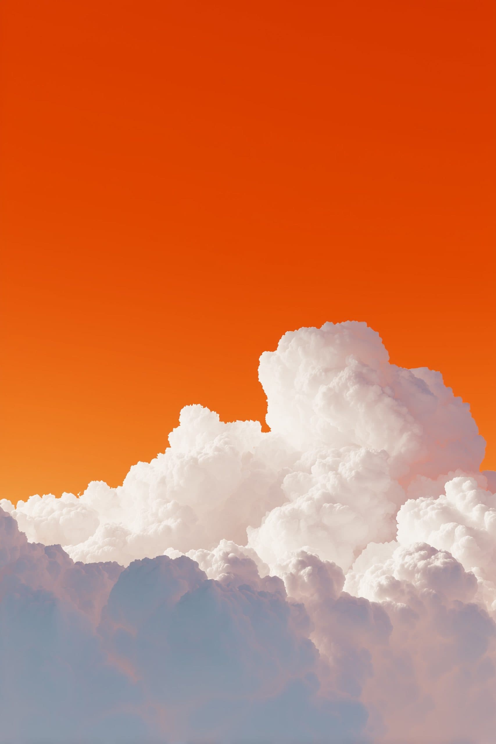 Beautiful white clouds against an orange sunset sky.
