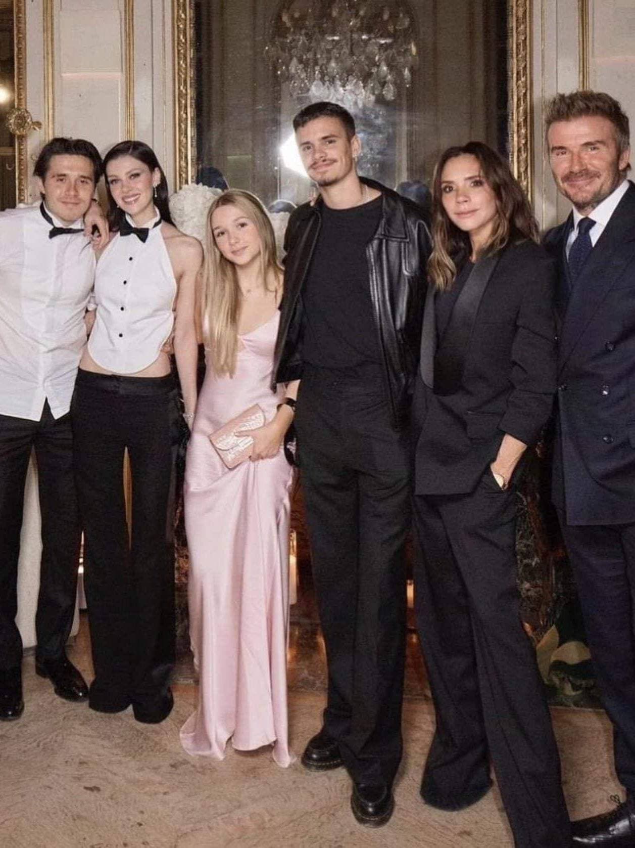 Inside the Beckham family celebrating together at a formal event.