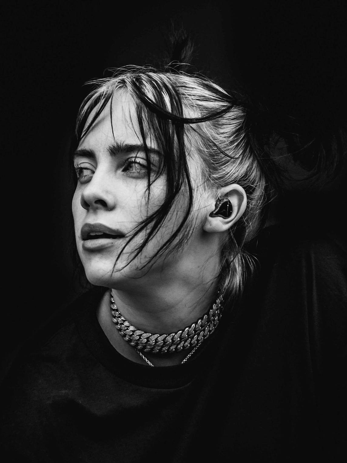 Billie Eilish in a contemplative pose, emphasizing themes of belonging and authenticity related to