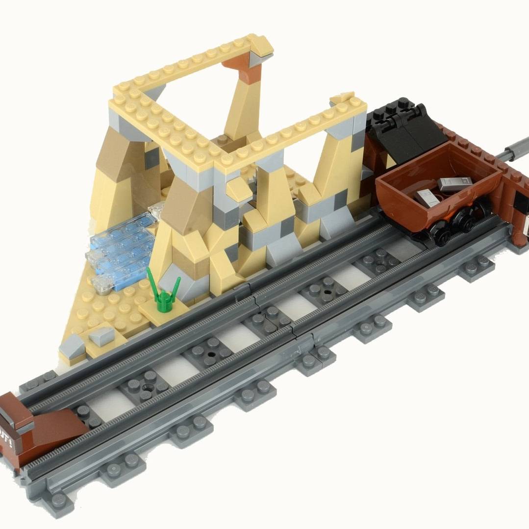 LEGO mining construction set featuring a track, excavator, and cart for creative play and building.