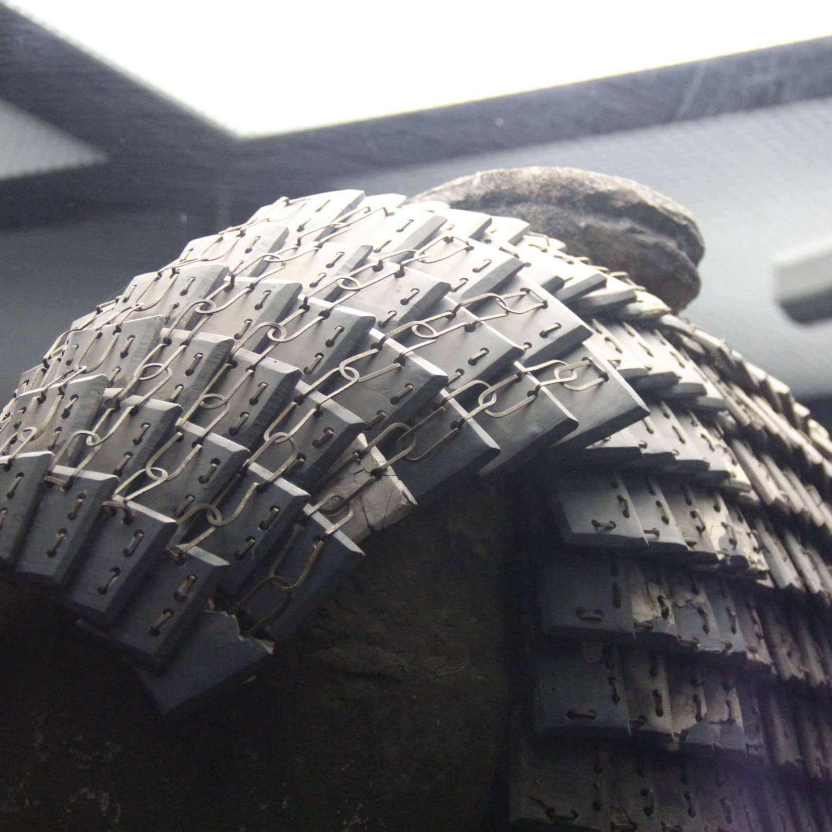Tire with advanced metal link technology for durability and performance.