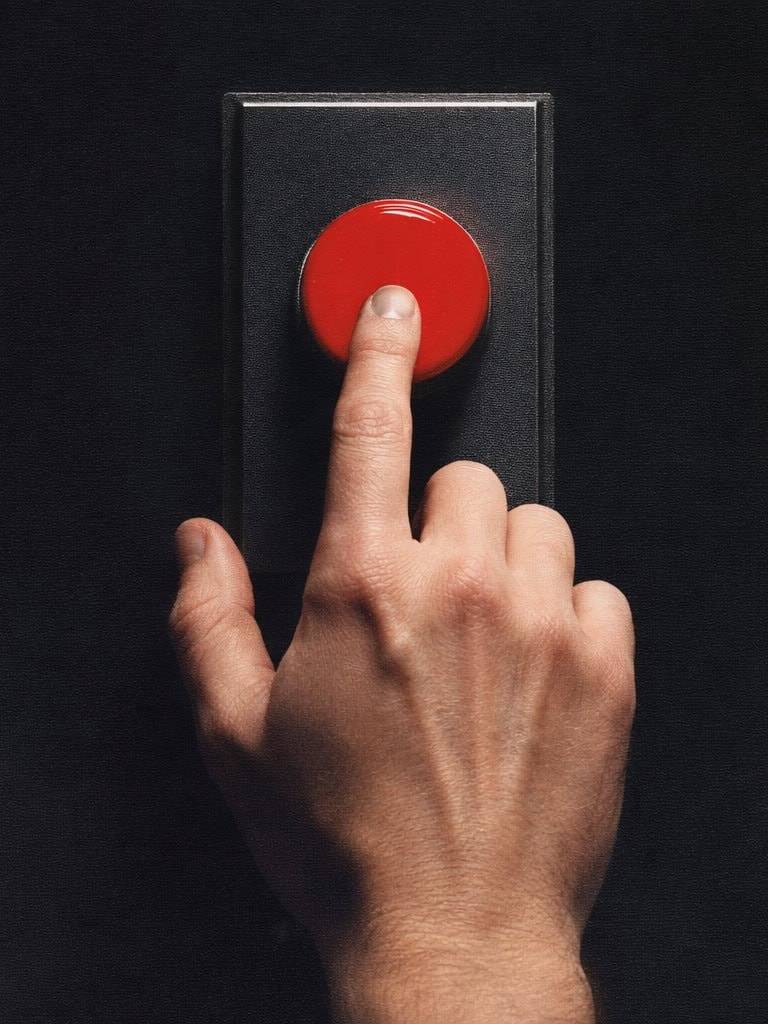 Hand pressing red button symbolizing emotional control and inner shift.