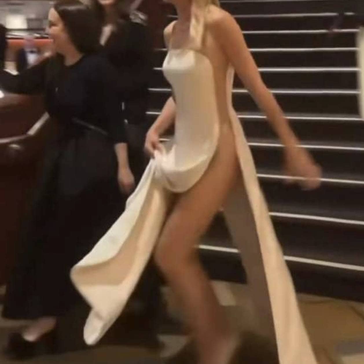 Celebrity on the red carpet wearing a daring gown with a dramatic train at The Naked Red Carpet even.