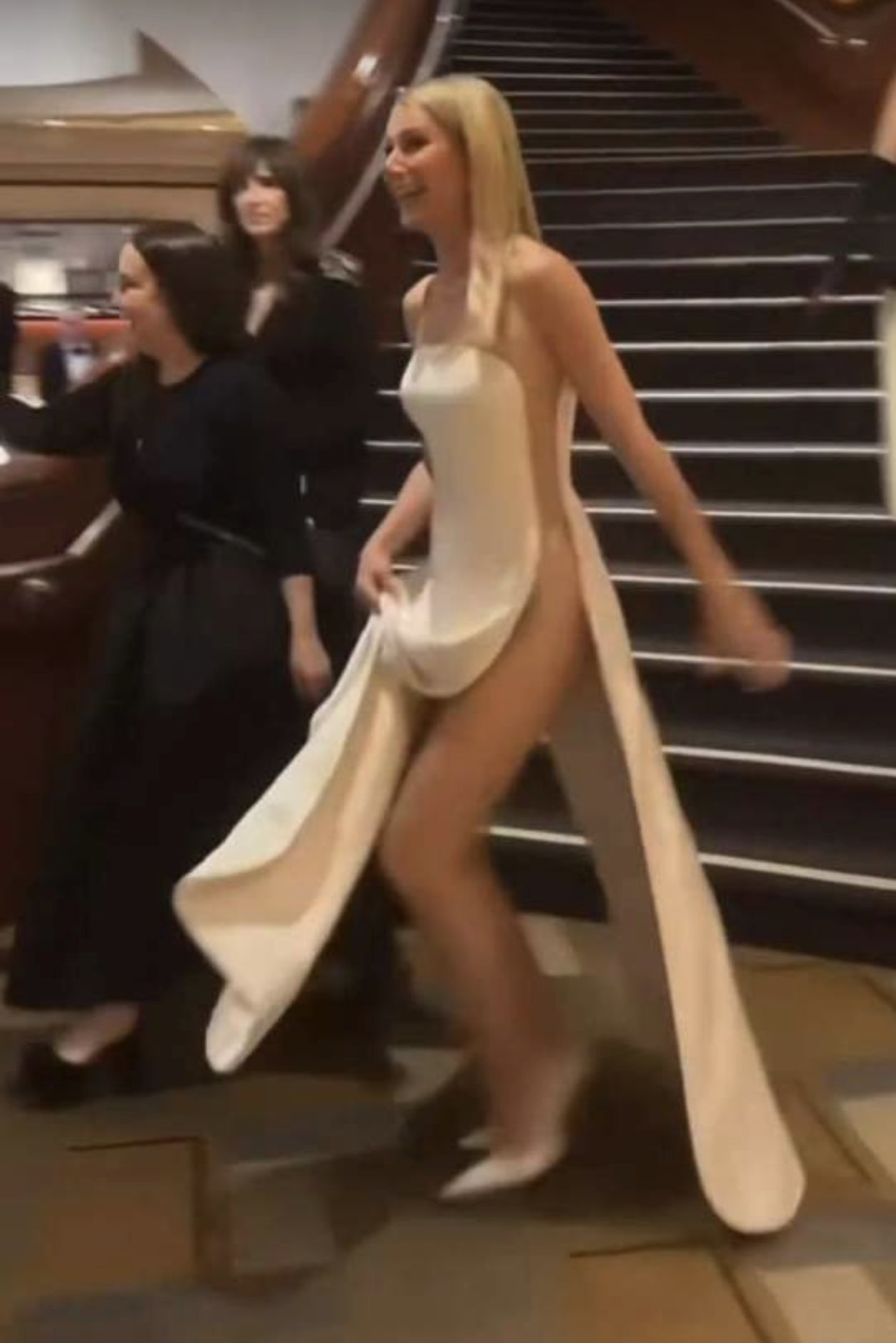 Celebrity on the red carpet wearing a daring gown with a dramatic train at The Naked Red Carpet even.