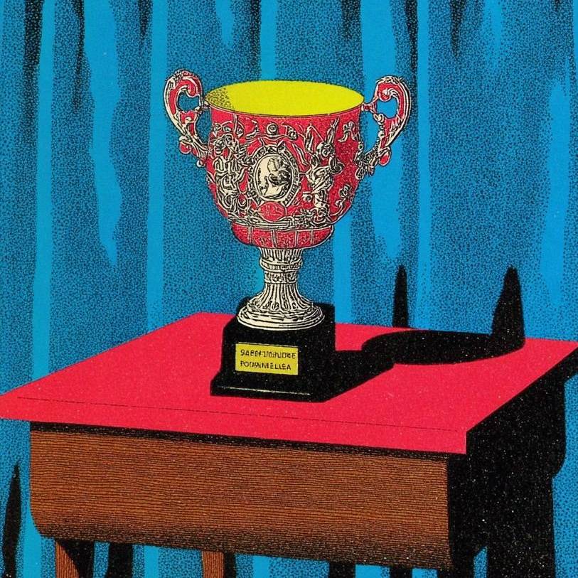 Elegant silver trophy with ornate handles on a red table.
