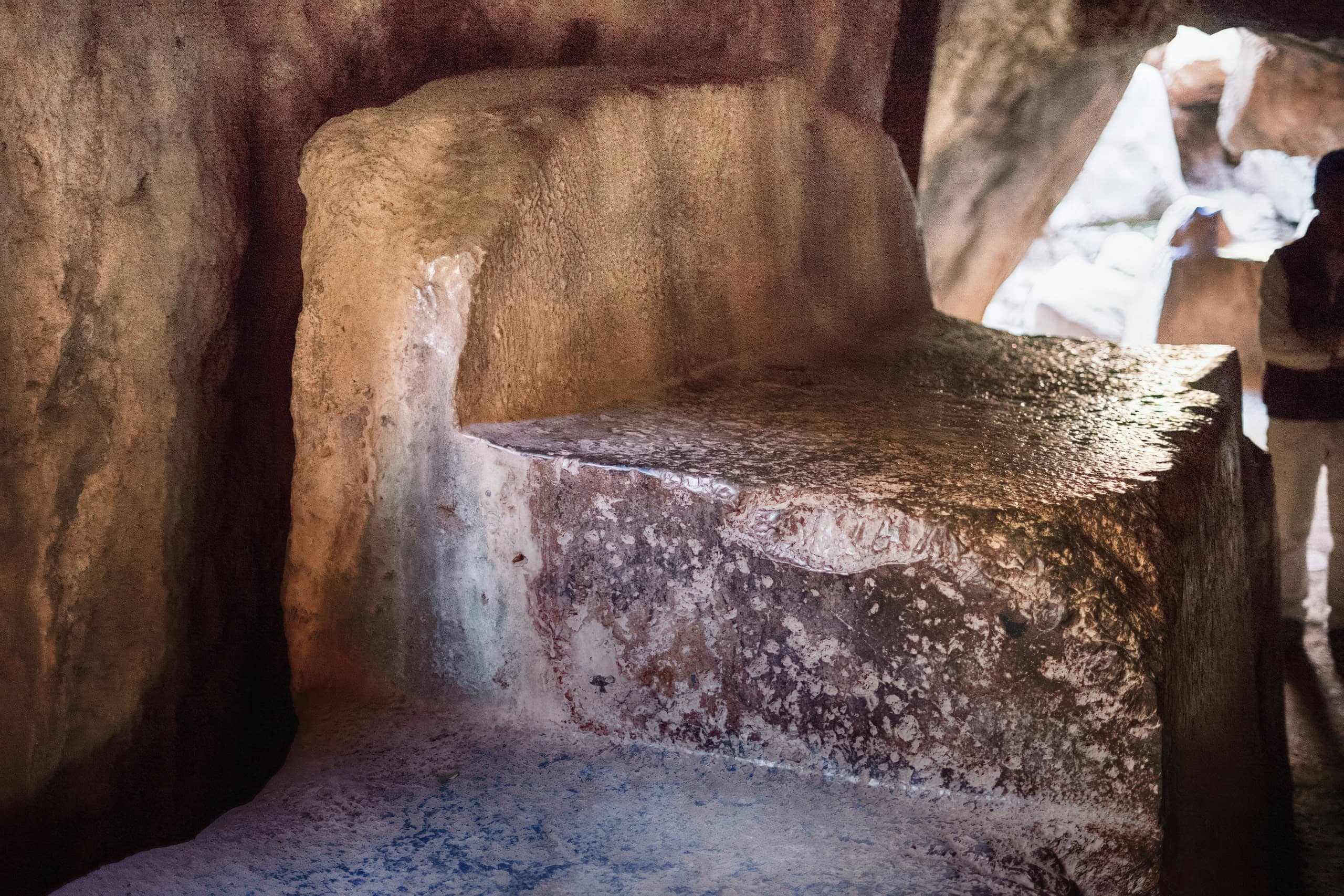 Ancient stone seat carved from natural rock at Grain of Gold archaeological site.