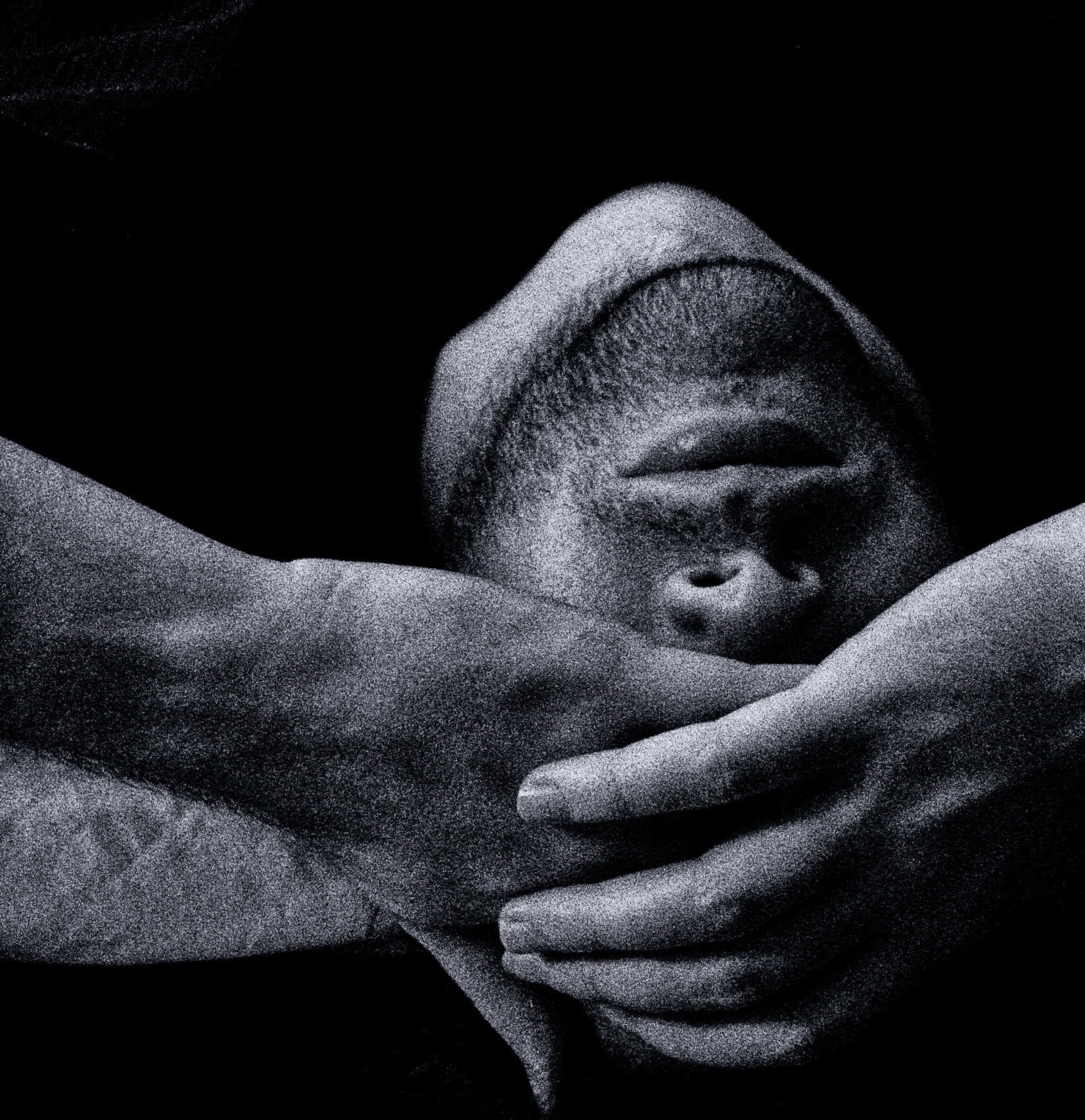 Portrait of a person covering their face, symbolizing shame and vulnerability.