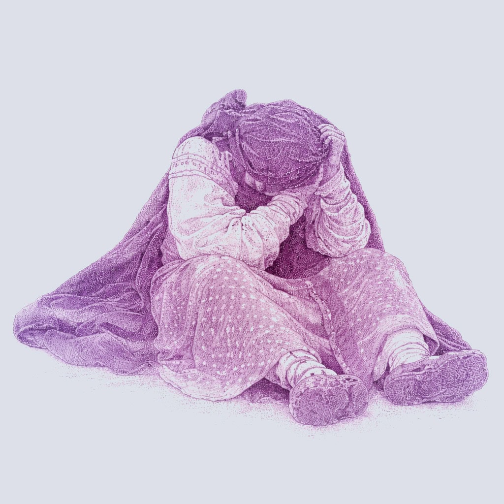 Child sitting on the ground with head resting in hands, conveying emotion or contemplation.