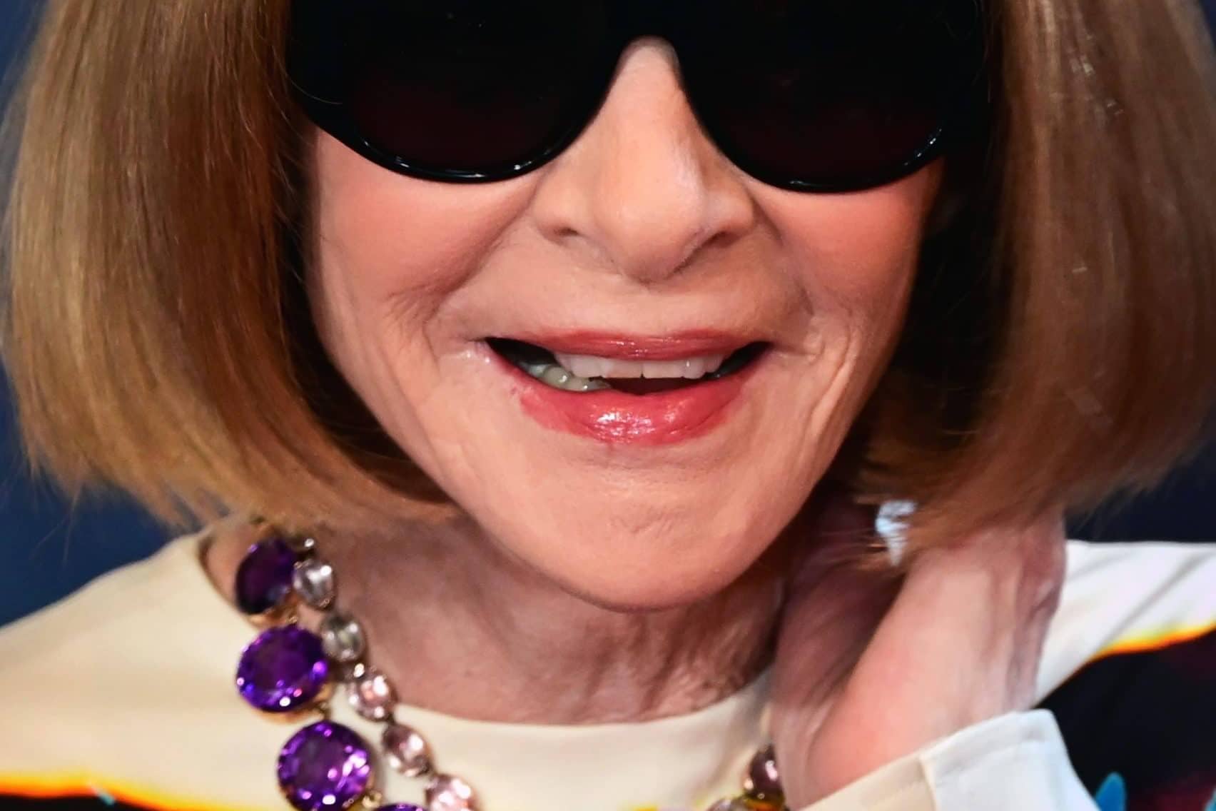 Elegant woman with sunglasses and statement jewelry at the Met Gala.