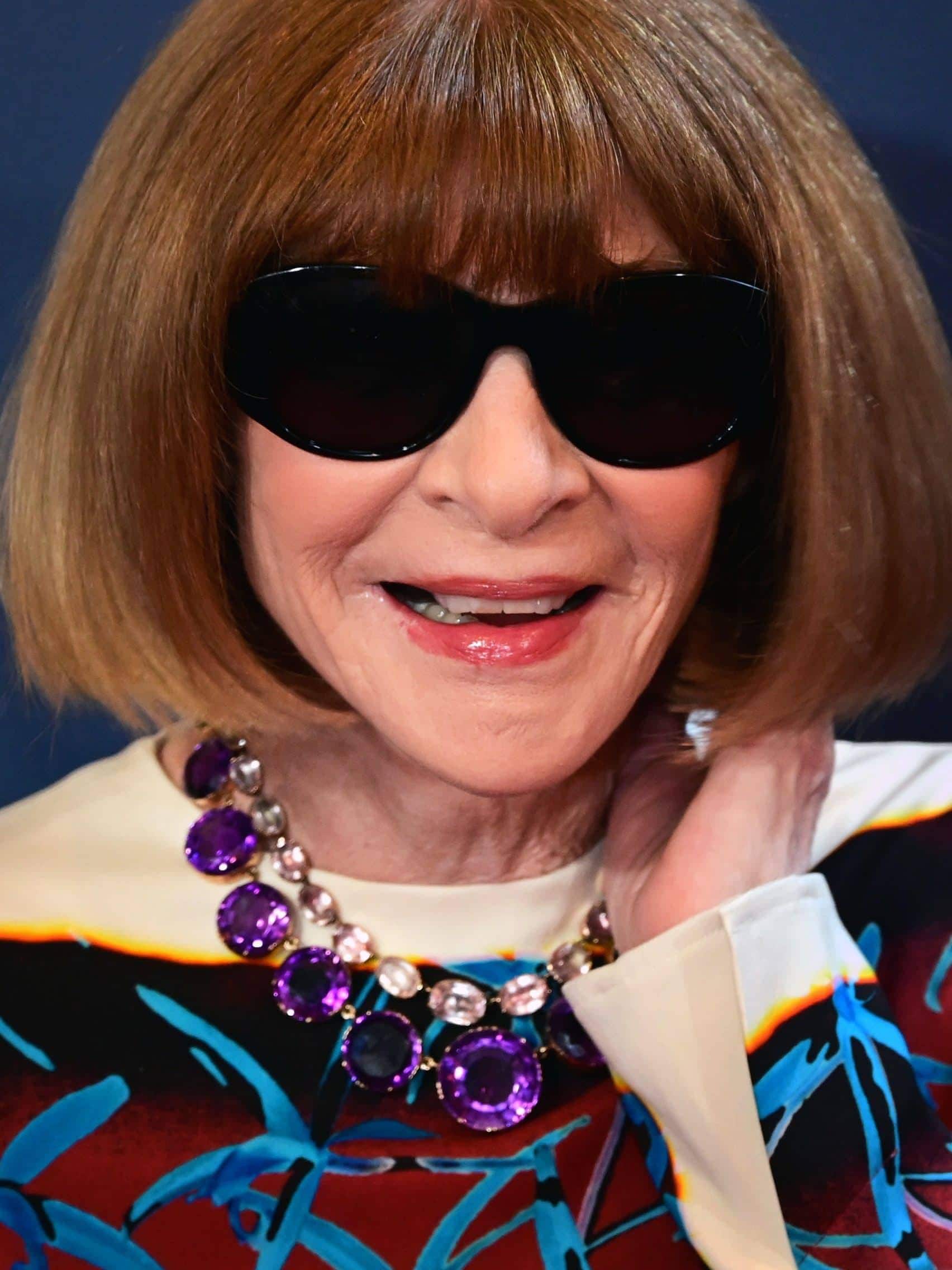 Elegant woman with sunglasses and statement jewelry at the Met Gala.