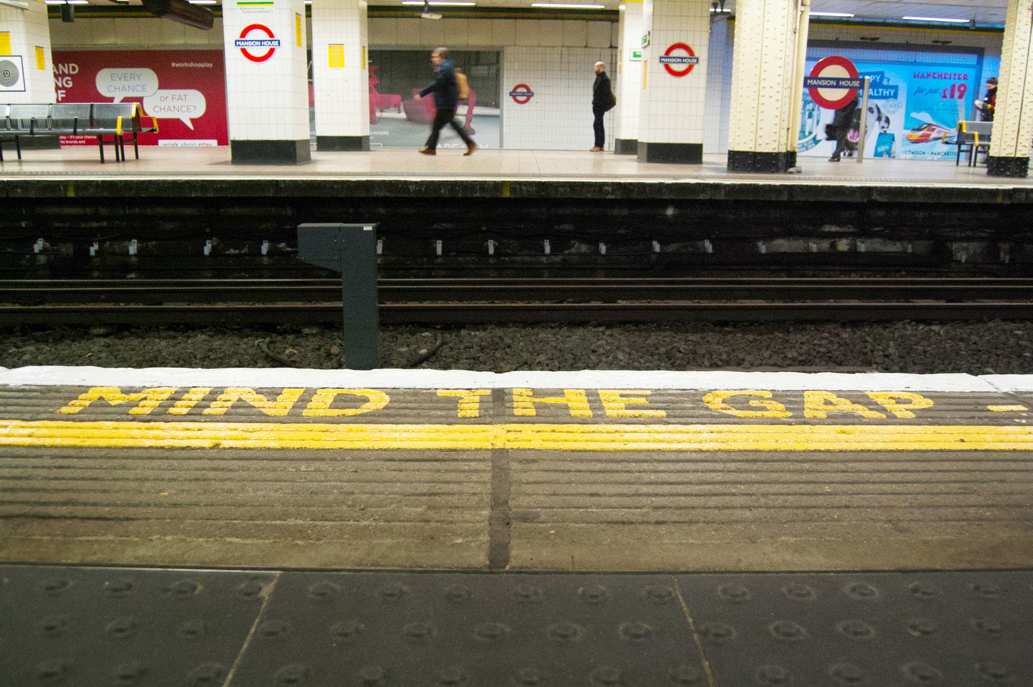 London Underground platform with 'FIND THE GAP' warning in yellow paint.