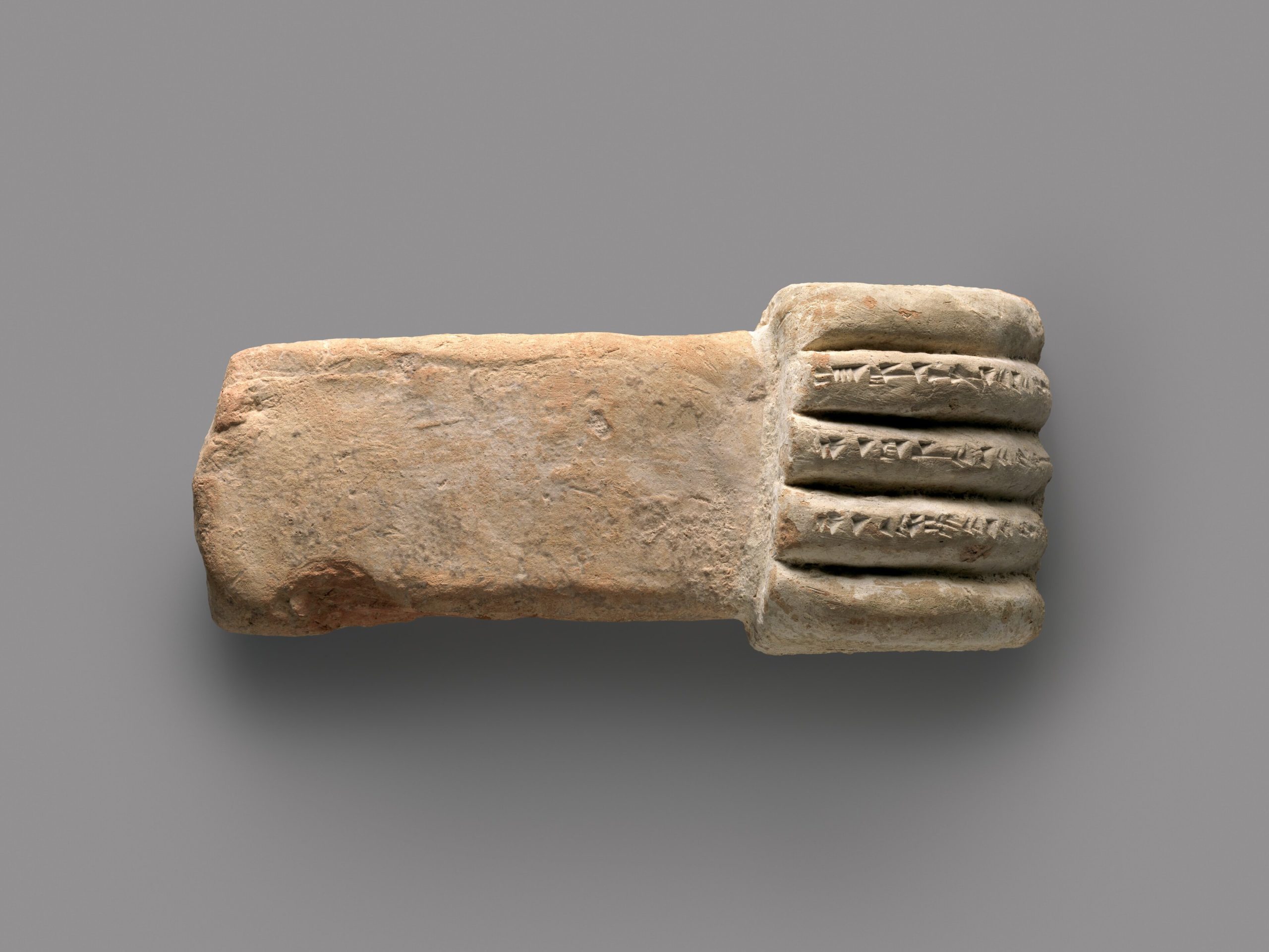 Ancient clay artifact featuring a symbol representing inhumanity, linked to themes in