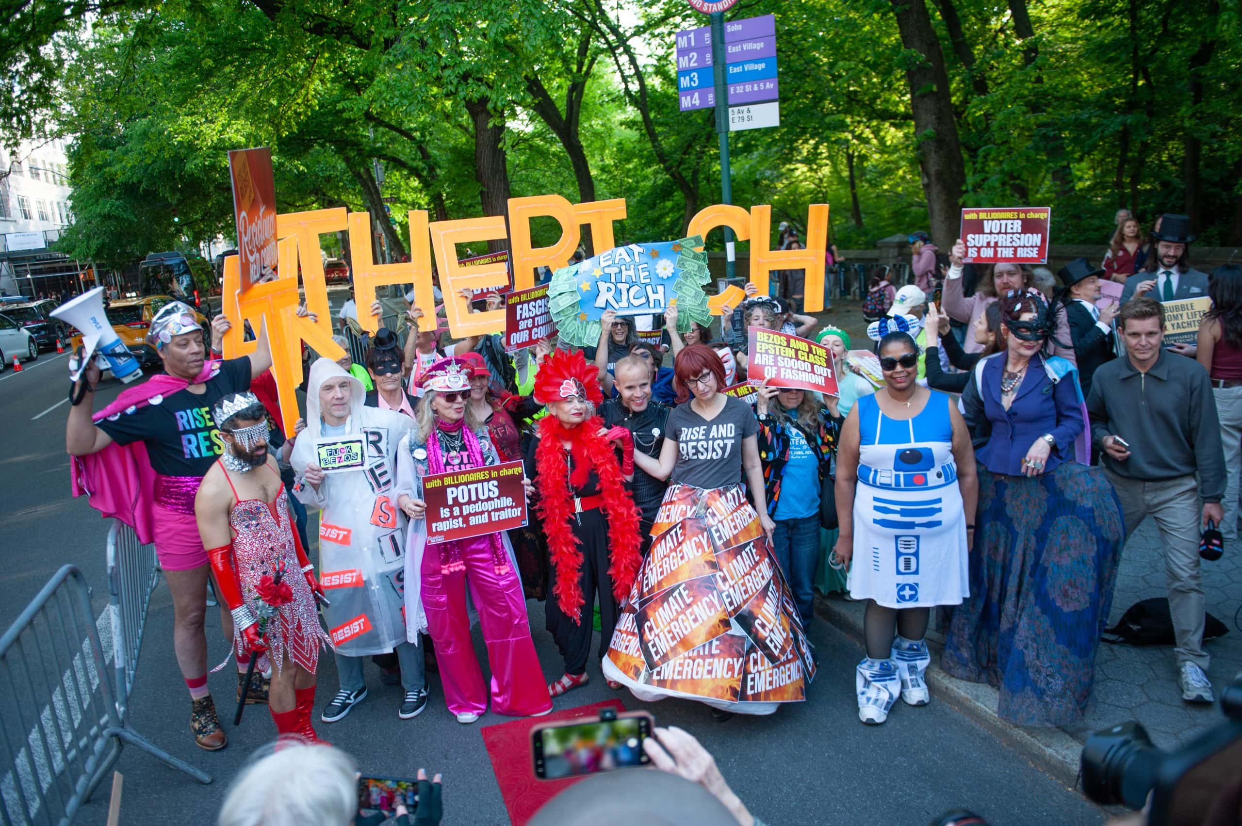 Protesters at the event highlight social issues, contrasting luxury fashion with activism and societ.