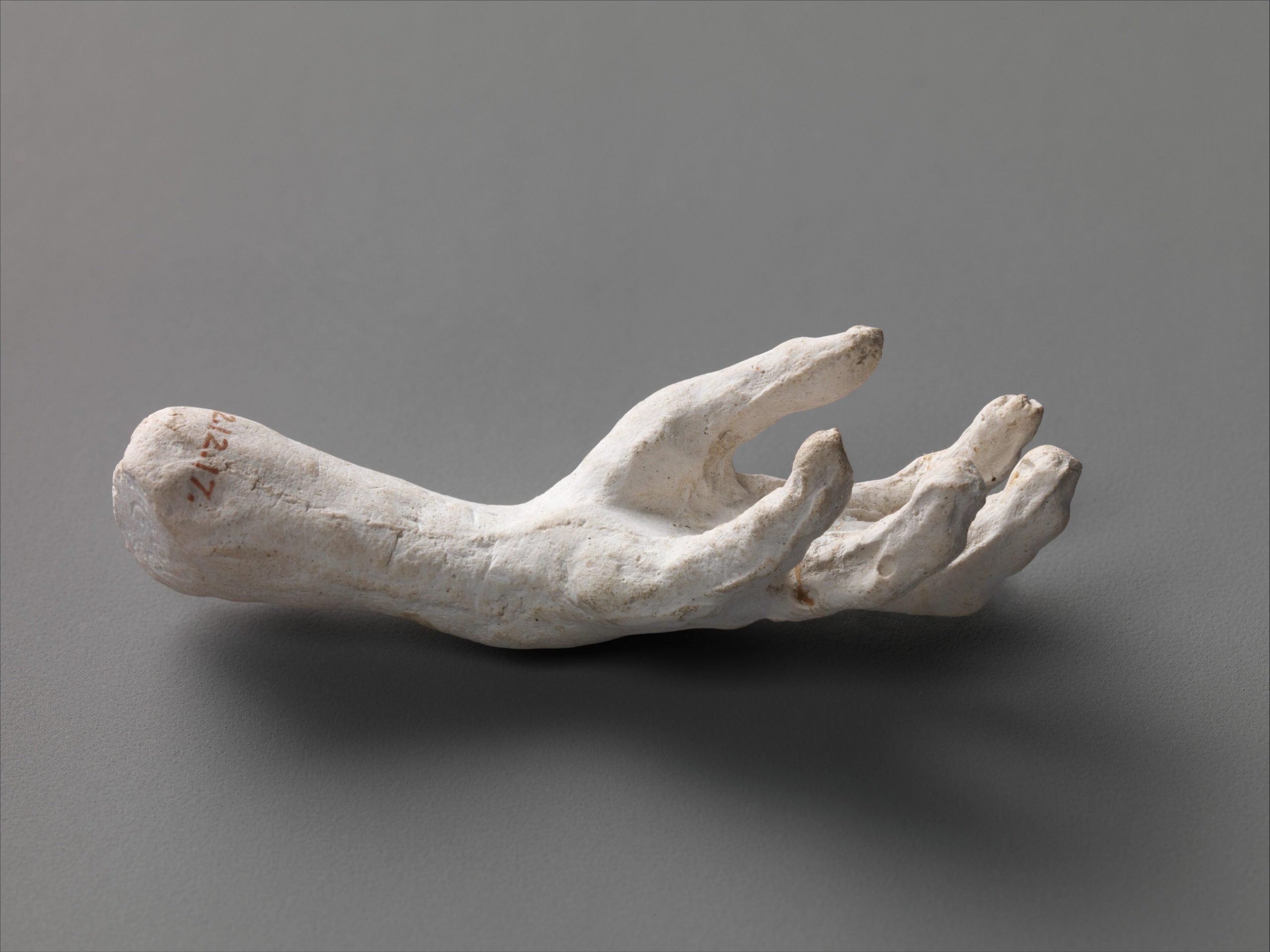 Hand sculpture representing inhumanity and human fragility.