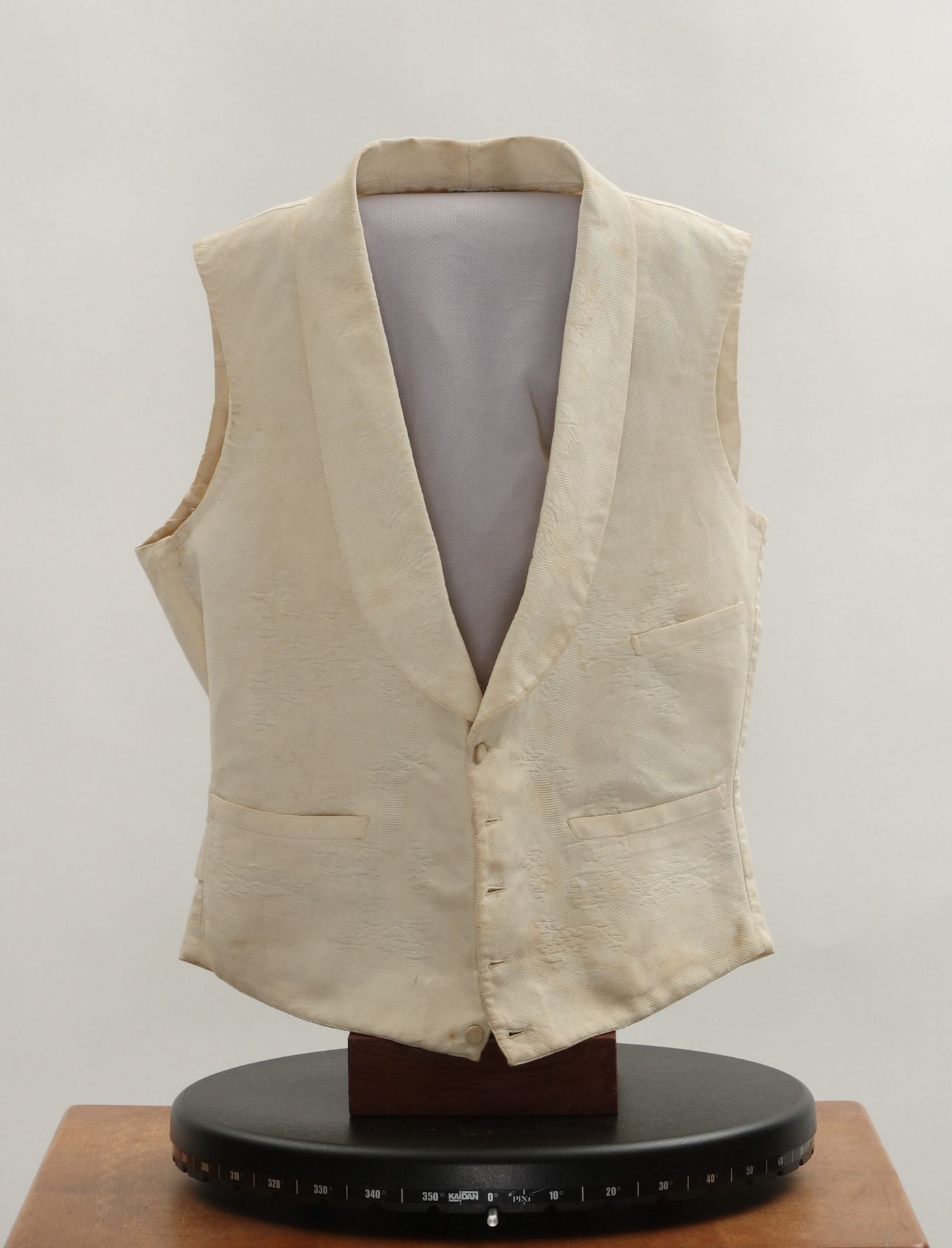 Vintage cream waistcoat on display for collectors and fashion enthusiasts.