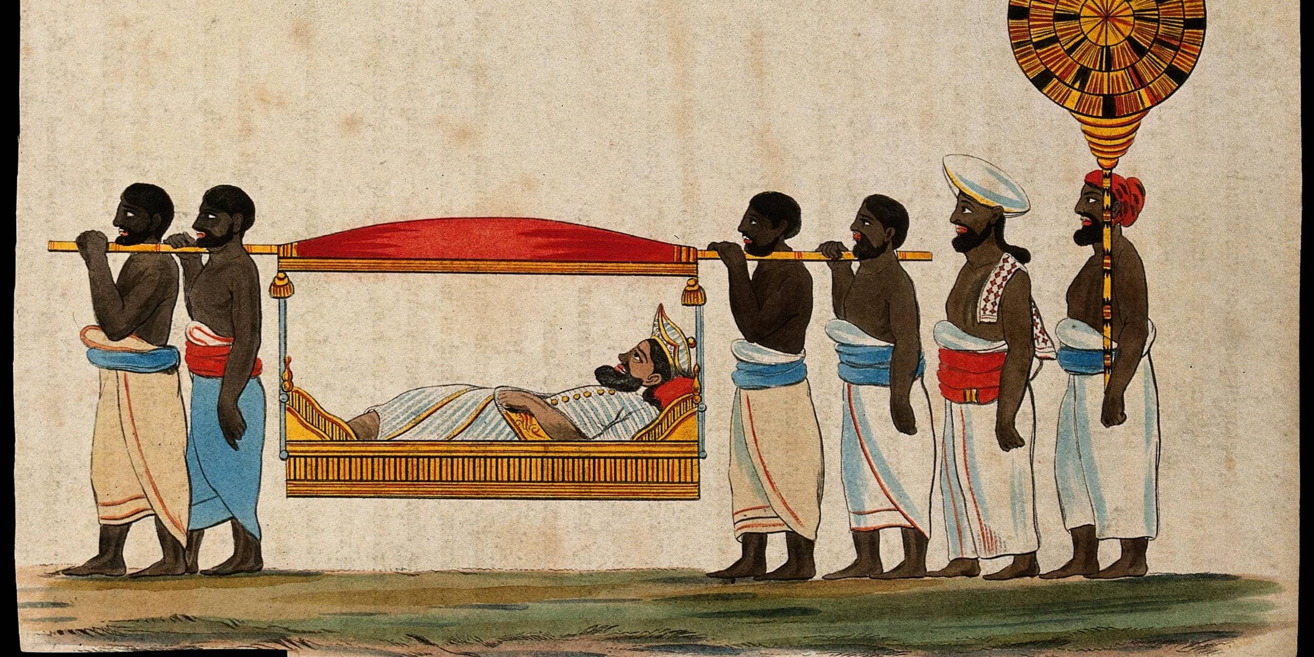 Indian funeral procession with pallbearers carrying a deceased on a decorated bier.