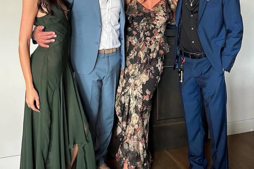Family dressed elegantly at GRAINOFGOLD event, smiling and posing indoors.