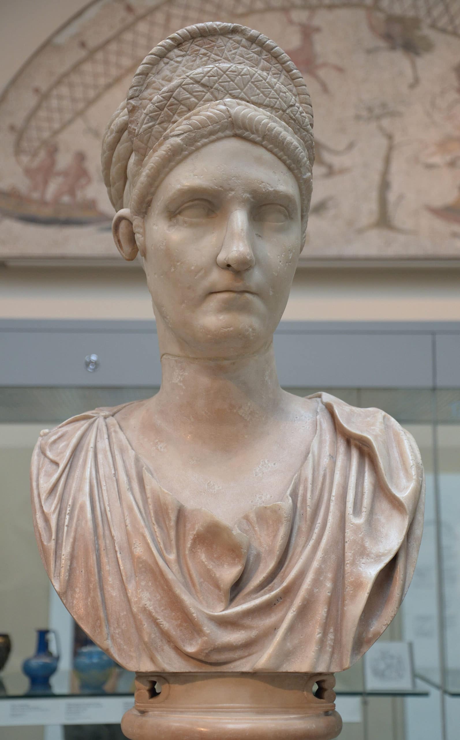 Roman marble bust of a woman with detailed hair and draped clothing.