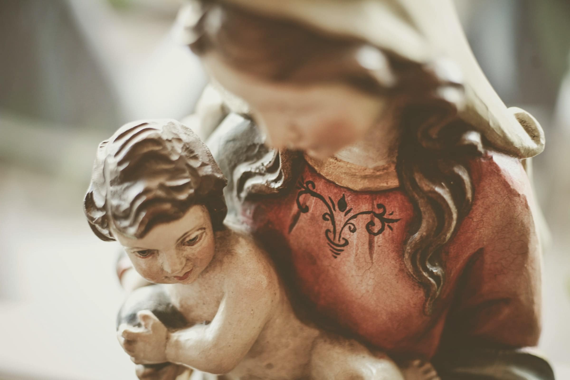 Close-up of a religious figurine depicting a woman and child, detailed craftsmanship.
